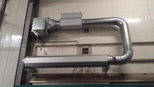 Masterveil AS-K air curtain installed above a freezer room door with duct connection and fan unit for energy-efficient separation of cold air.